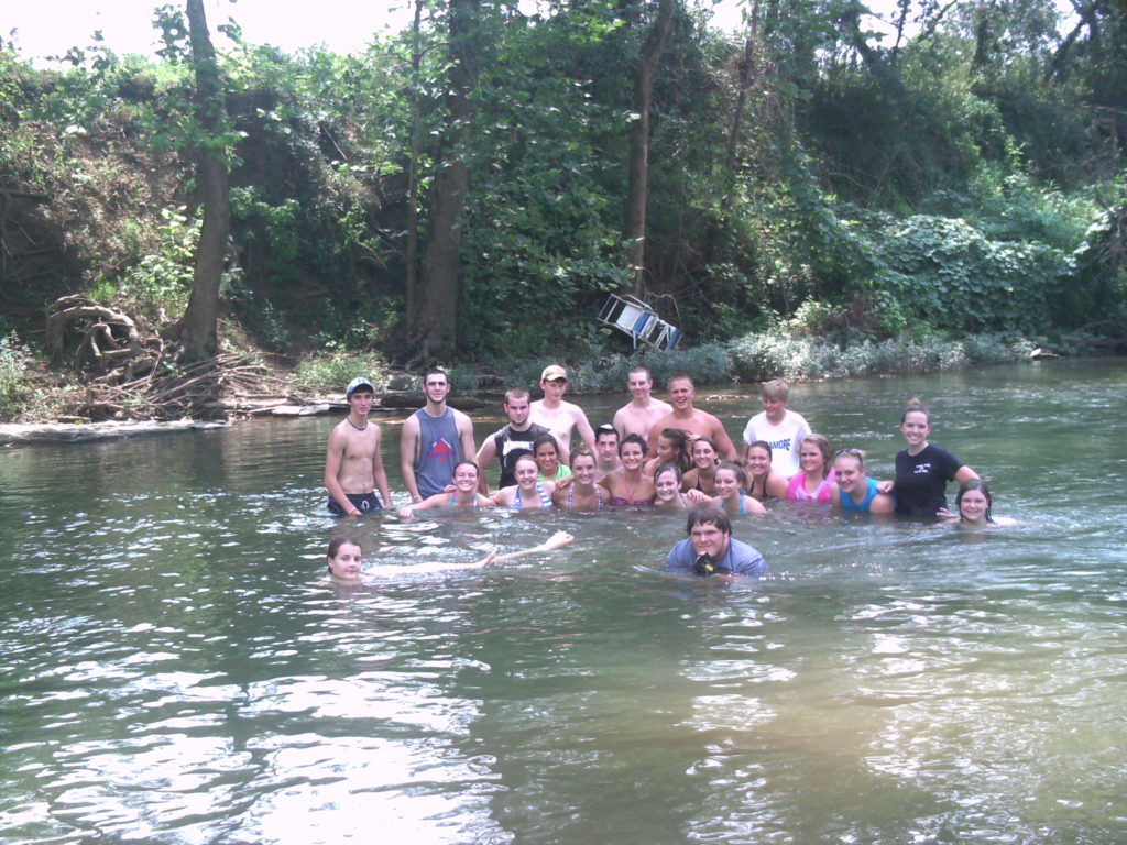 YLCC Class of 2010-2011 standing in a river